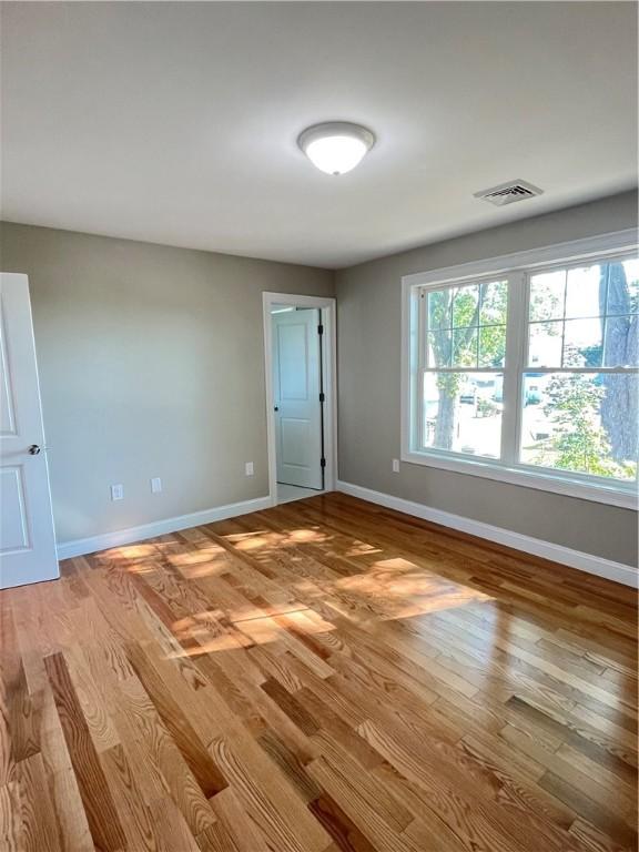 unfurnished room featuring light hardwood / wood-style flooring