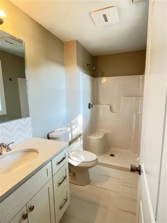 bathroom with a shower, toilet, and vanity