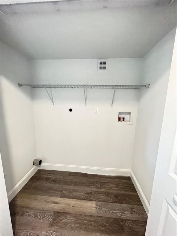 washroom with dark hardwood / wood-style floors, washer hookup, and electric dryer hookup