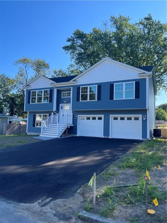 raised ranch featuring a garage and central AC