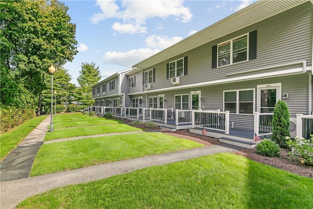 rear view of property featuring a lawn