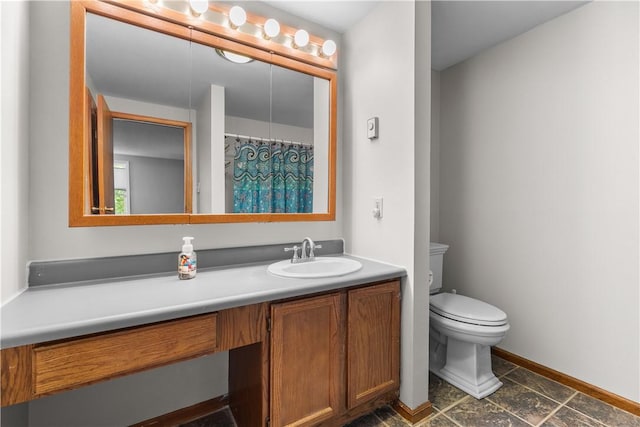 bathroom featuring toilet and vanity