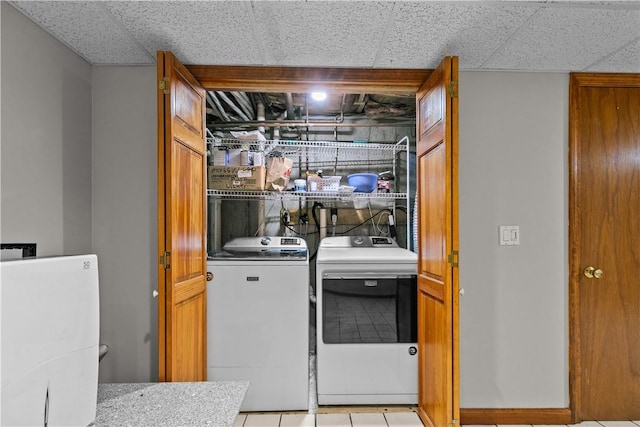 laundry room featuring light tile patterned floors and washer and dryer