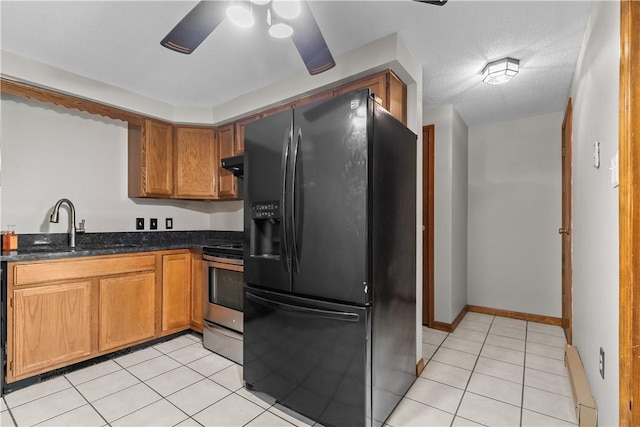 kitchen with black refrigerator with ice dispenser, light tile patterned floors, sink, and stainless steel electric range