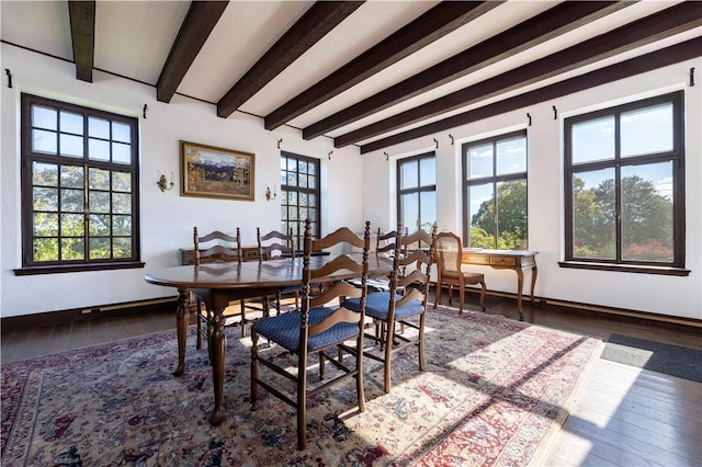 dining area featuring beam ceiling, dark hardwood / wood-style flooring, and a wealth of natural light