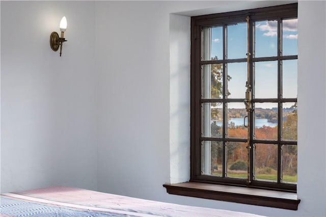 unfurnished bedroom featuring a water view