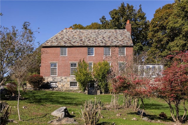 view of side of home with a yard