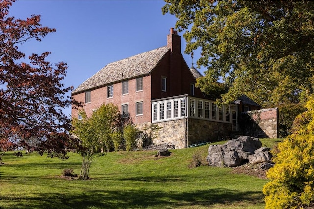 view of side of home featuring a lawn