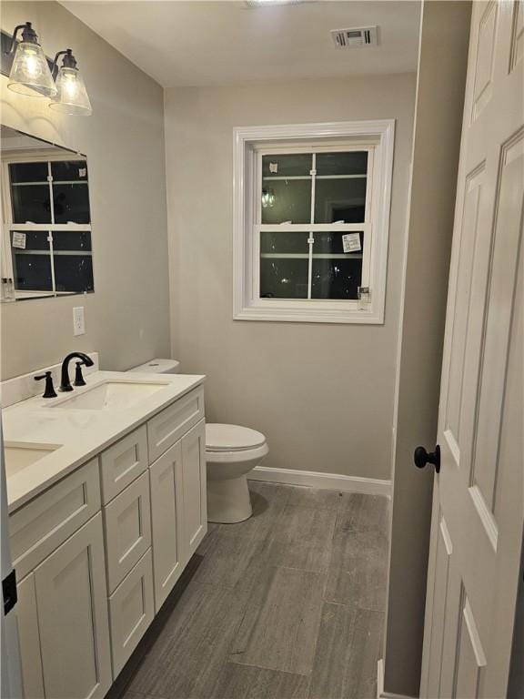 bathroom featuring toilet and vanity