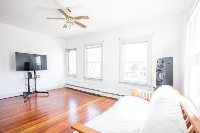 living room featuring ceiling fan, hardwood / wood-style flooring, washer / dryer, and a baseboard radiator