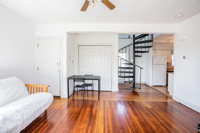 living room with ceiling fan and dark hardwood / wood-style floors