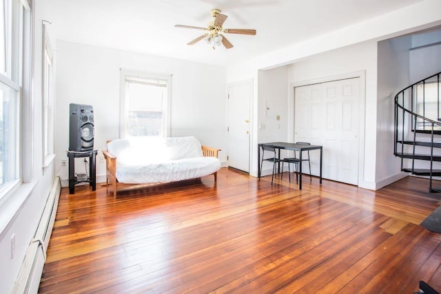 sitting room with ceiling fan, a wealth of natural light, and hardwood / wood-style floors