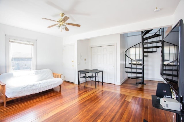 living area with ceiling fan and wood-type flooring