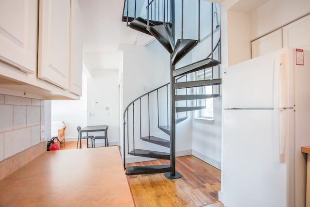 staircase featuring wood-type flooring