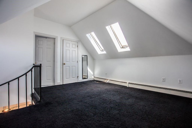 bonus room featuring lofted ceiling with skylight, a baseboard radiator, and carpet floors