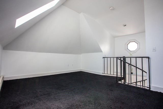 additional living space with carpet and lofted ceiling with skylight