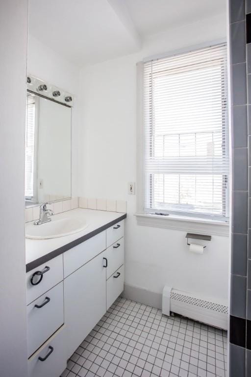 bathroom with baseboard heating, tile patterned floors, and vanity