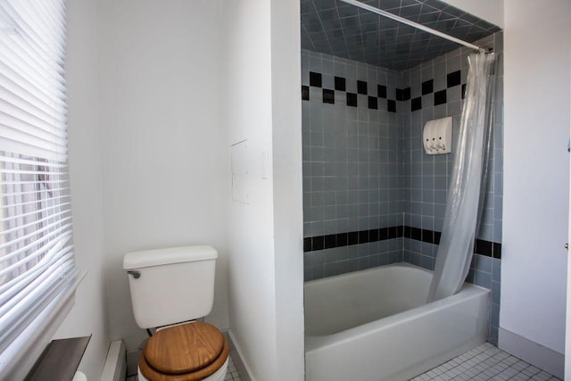 bathroom featuring toilet, a healthy amount of sunlight, shower / bathtub combination with curtain, and tile patterned floors