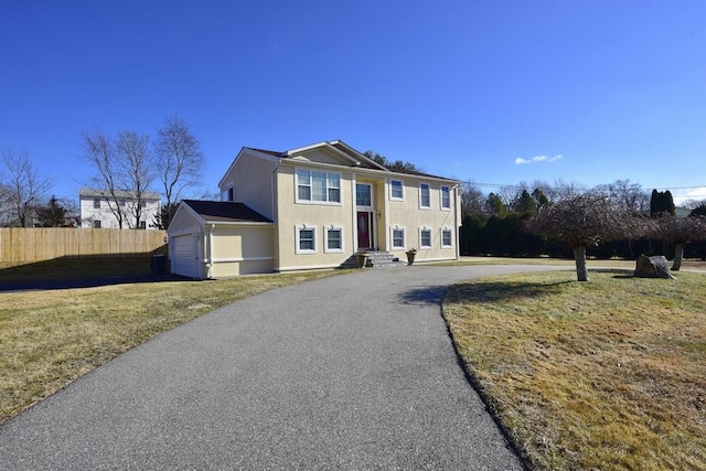 view of front of house with a front yard and a garage