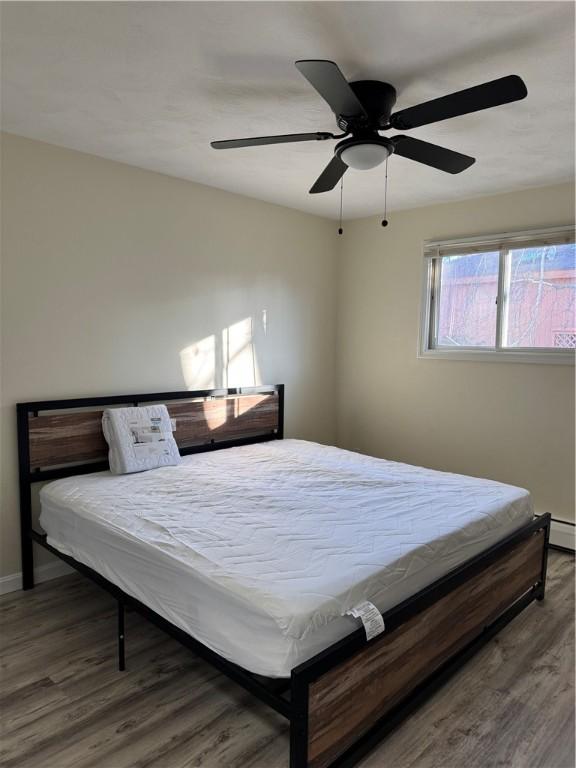 bedroom featuring ceiling fan and dark wood-type flooring