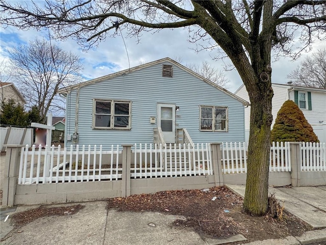 bungalow-style home with a fenced front yard