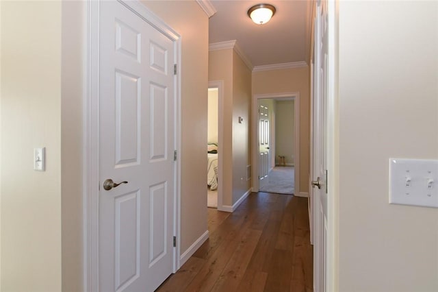 corridor featuring dark hardwood / wood-style flooring and crown molding