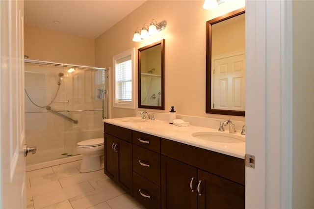 bathroom featuring toilet, vanity, and an enclosed shower