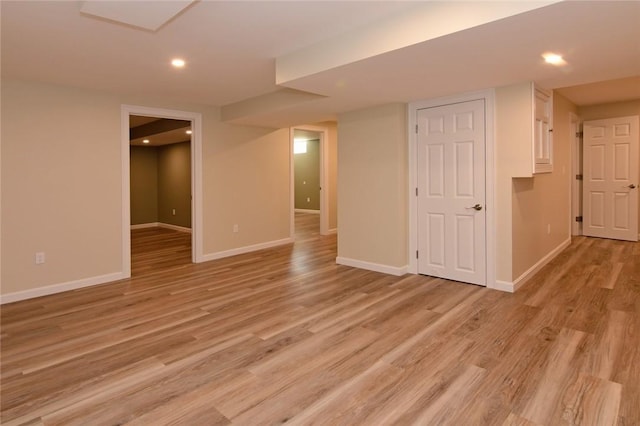 basement with light hardwood / wood-style floors