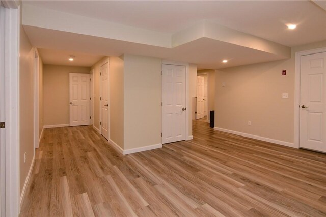 basement with light hardwood / wood-style flooring