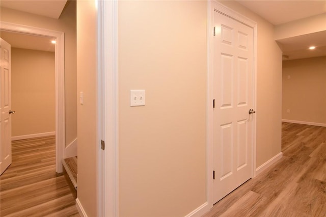 hallway with light hardwood / wood-style floors