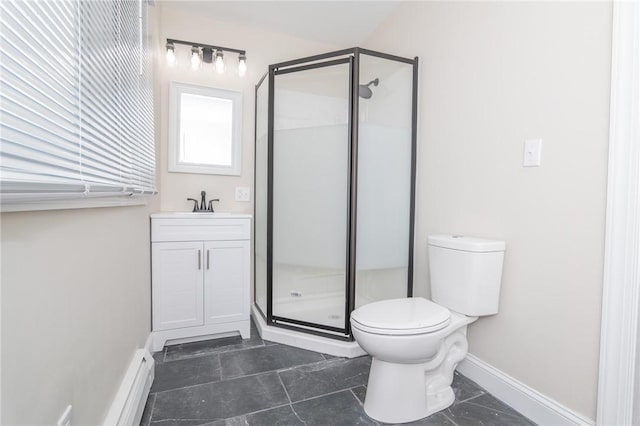 bathroom with a shower with shower door, vanity, and toilet