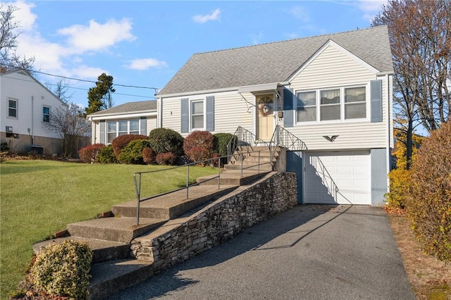 view of front of property with a garage and a front yard