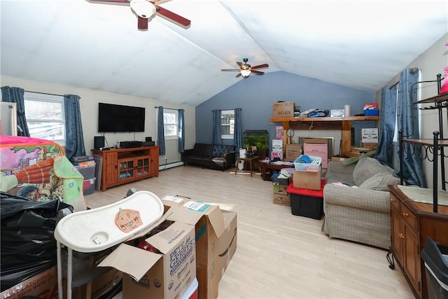 living room with ceiling fan, light hardwood / wood-style floors, lofted ceiling, and a healthy amount of sunlight