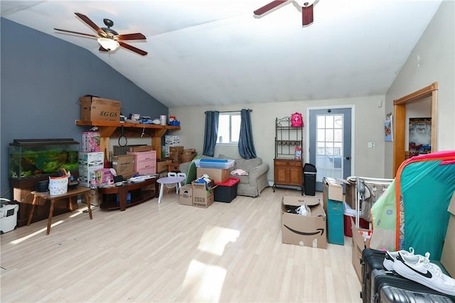 interior space with light wood-type flooring, vaulted ceiling, and ceiling fan