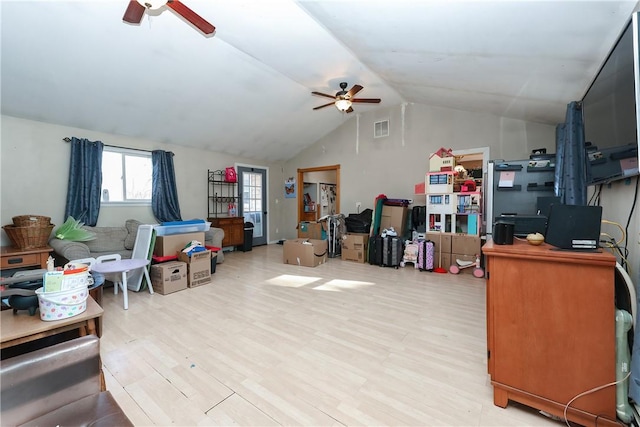 interior space with ceiling fan, lofted ceiling, and light hardwood / wood-style floors