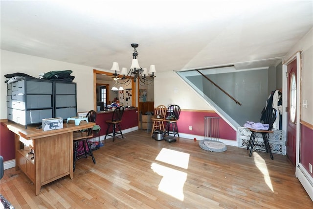 office area featuring a baseboard heating unit, hardwood / wood-style floors, and a notable chandelier