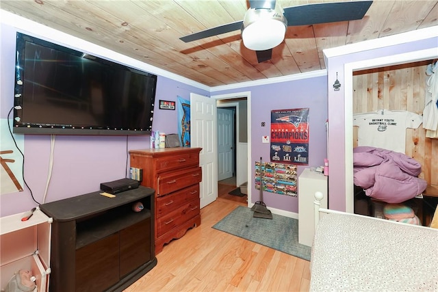 bedroom featuring ceiling fan, wood ceiling, crown molding, and light hardwood / wood-style flooring