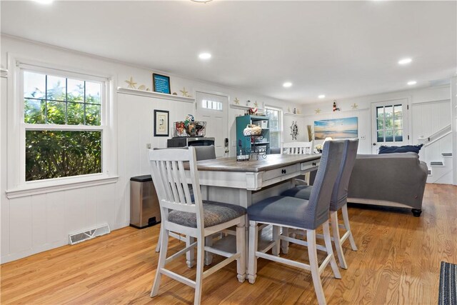 dining room featuring ornamental molding and light hardwood / wood-style floors