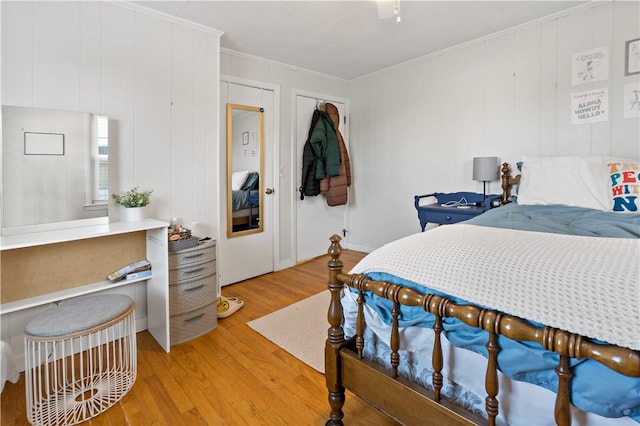 bedroom with hardwood / wood-style floors and crown molding