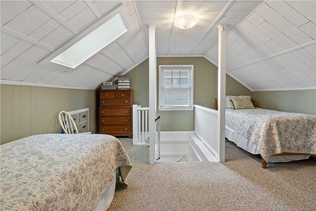 bedroom featuring carpet floors and lofted ceiling with skylight