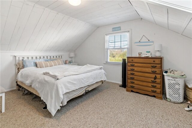 carpeted bedroom featuring vaulted ceiling and wooden ceiling