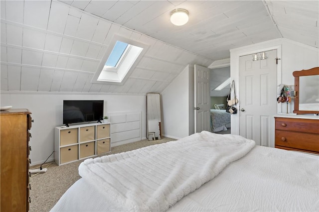 carpeted bedroom with lofted ceiling with skylight