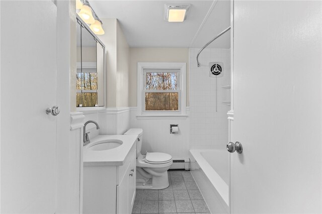 full bathroom with toilet, tiled shower / bath, a baseboard radiator, tile patterned flooring, and vanity