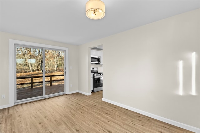 empty room with light hardwood / wood-style floors