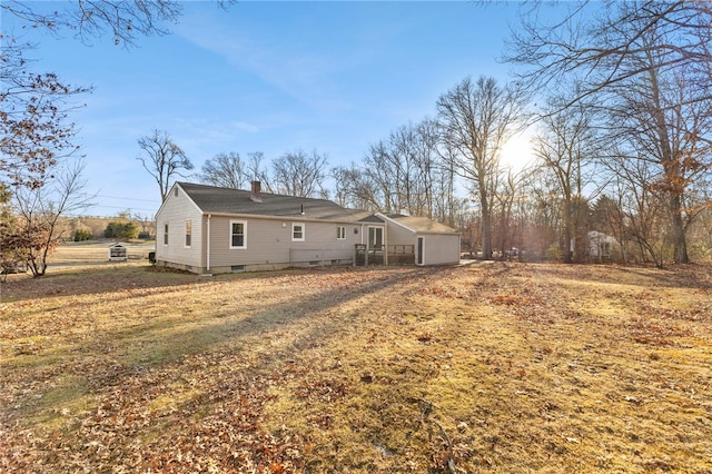 back of house with a lawn