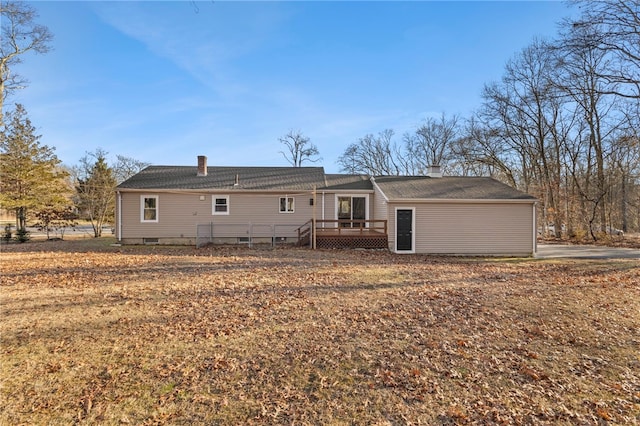 rear view of property featuring a deck