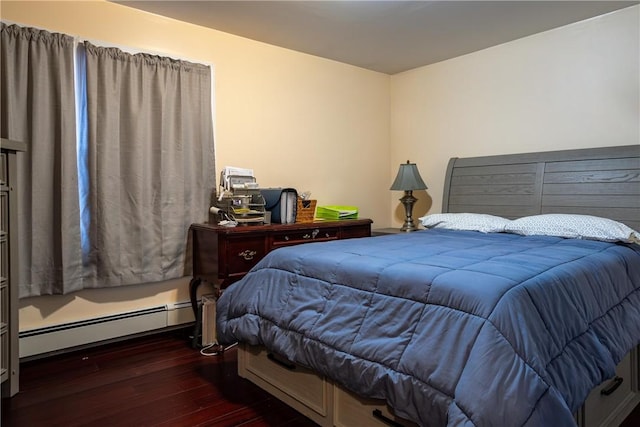 bedroom featuring a baseboard heating unit and dark hardwood / wood-style flooring