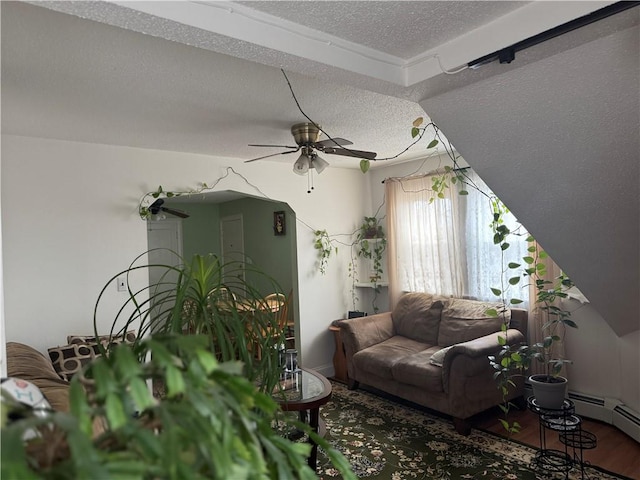 living room with ceiling fan, wood-type flooring, and a textured ceiling