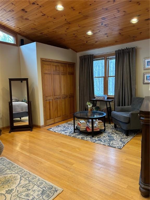 sitting room featuring vaulted ceiling, wooden ceiling, and wood-type flooring