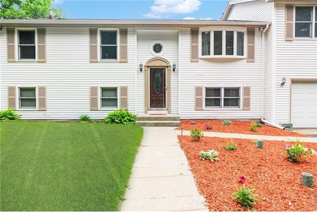 view of front facade with a garage and a front yard